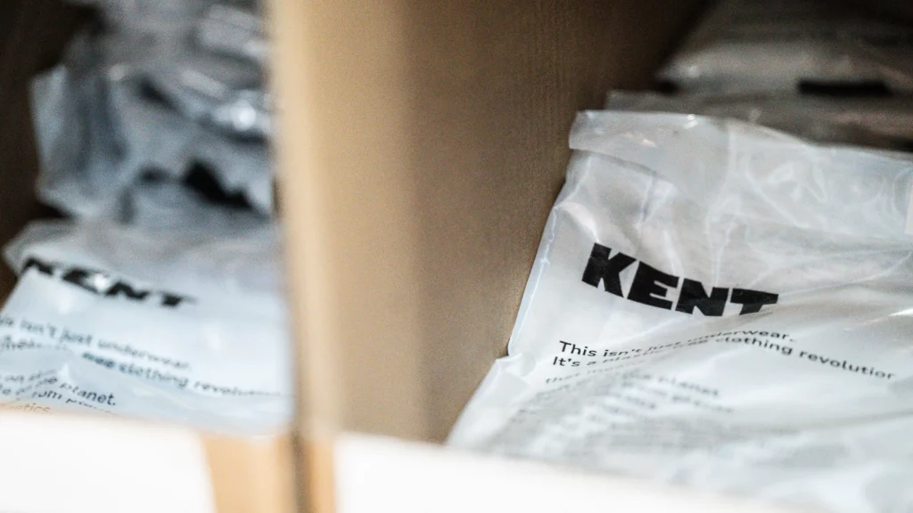 Close-up of branded poly mailer packaging stacked on a warehouse shelf